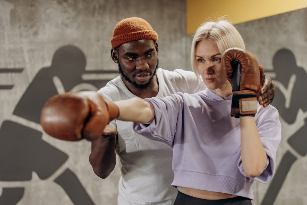 Woman Being Trained In Boxing