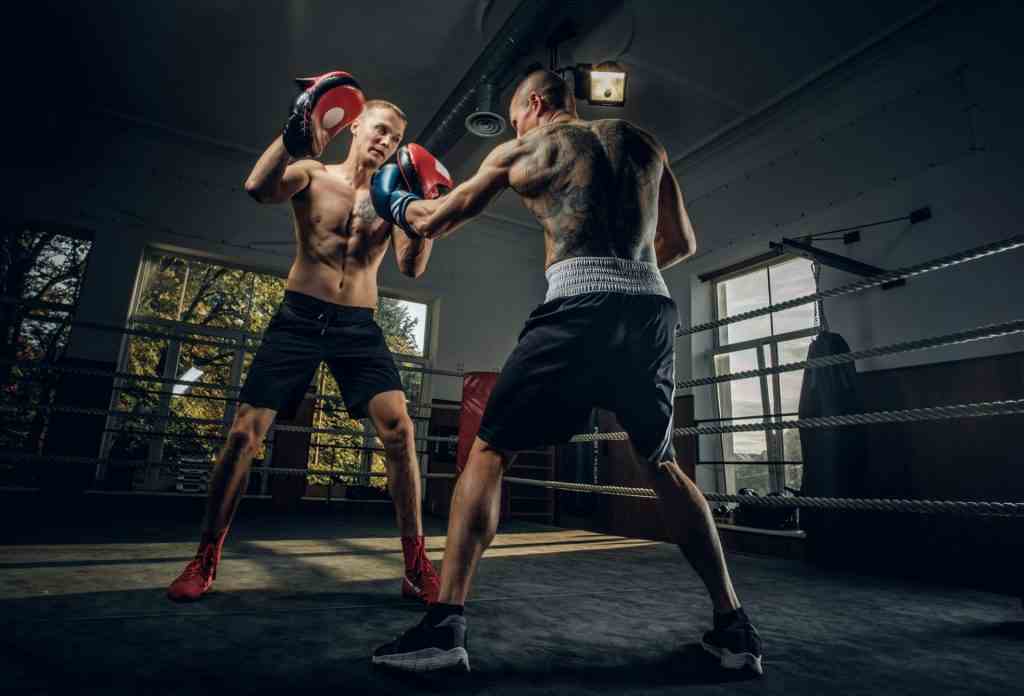 Two sportive men have a boxing competition on the ring