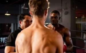 The boxing referee is explaining the rules before the two boxers fight,