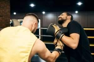 Boxer hitting his sparring partner with an uppercut