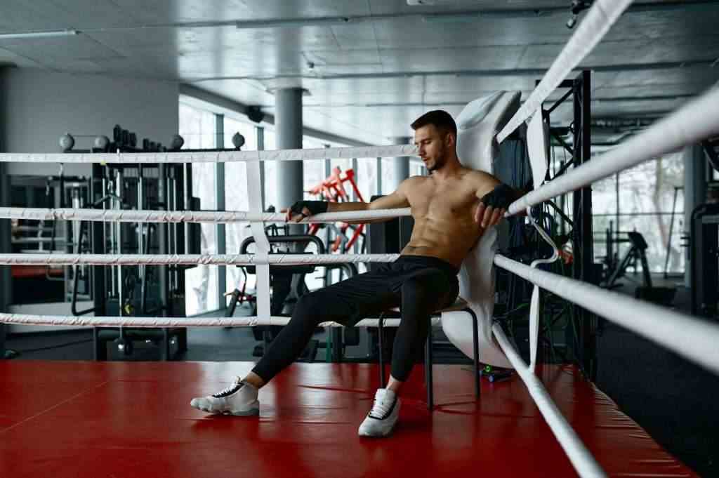 Boxer resting sit in boxer ring