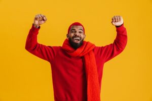 Excited african american guy screaming and showing winner gesture