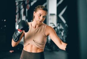 Fitness, sports and boxing with woman in gym for training, workout and mma challenge. Performance,